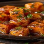 Spicy sticky vegan orange tofu with crispy edges and citrus glaze (118 characters)